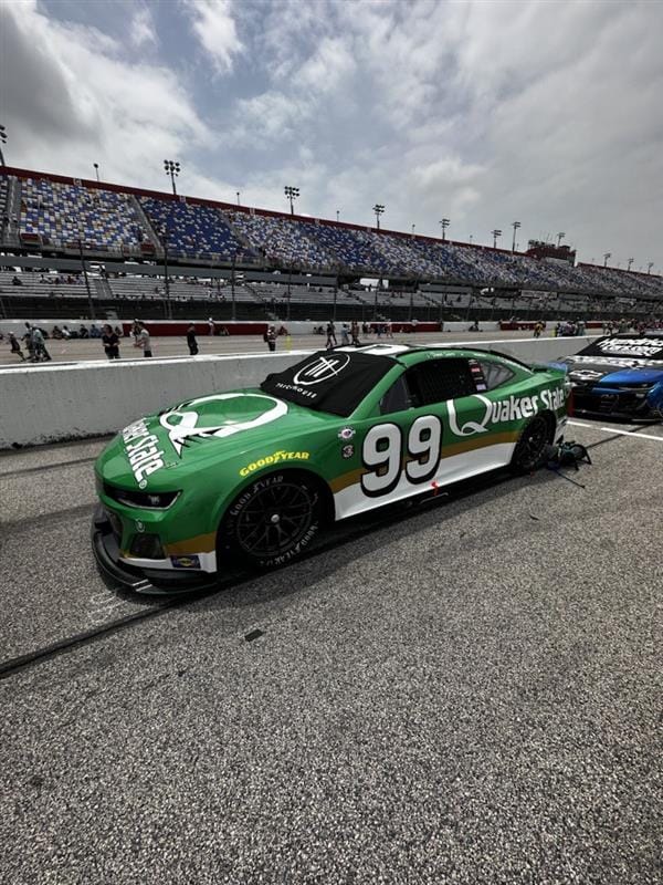 A green race car on a track