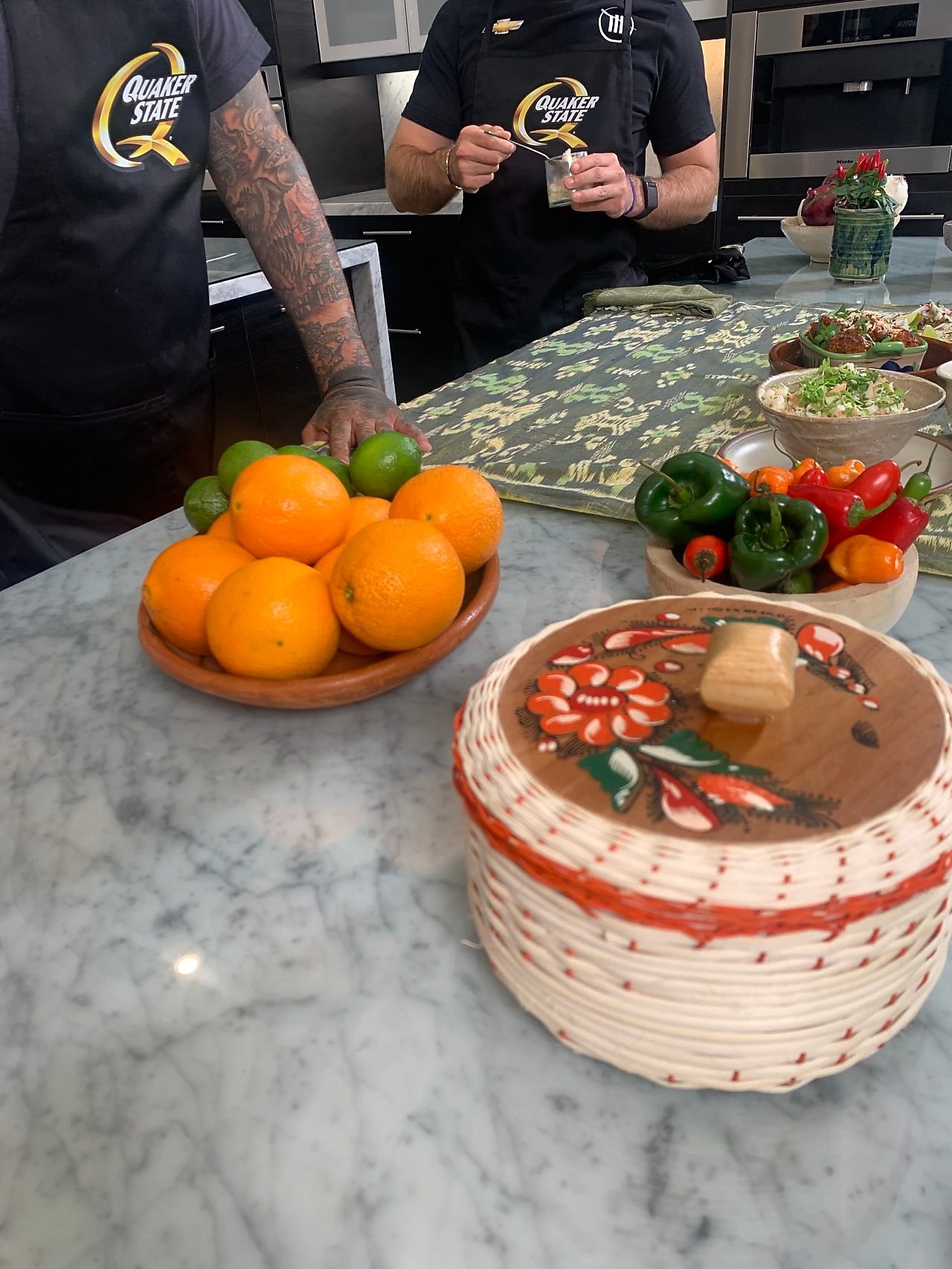 A person standing behind a table with food